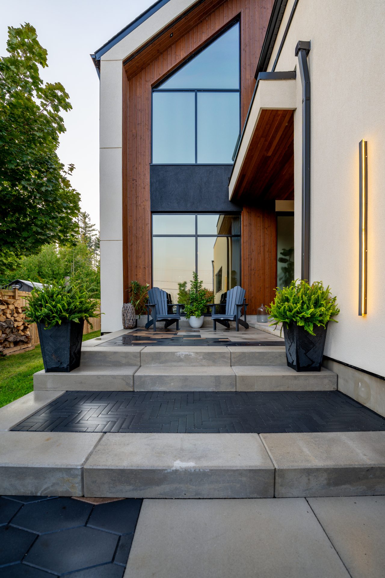 Modern house entrance with plants and chairs
