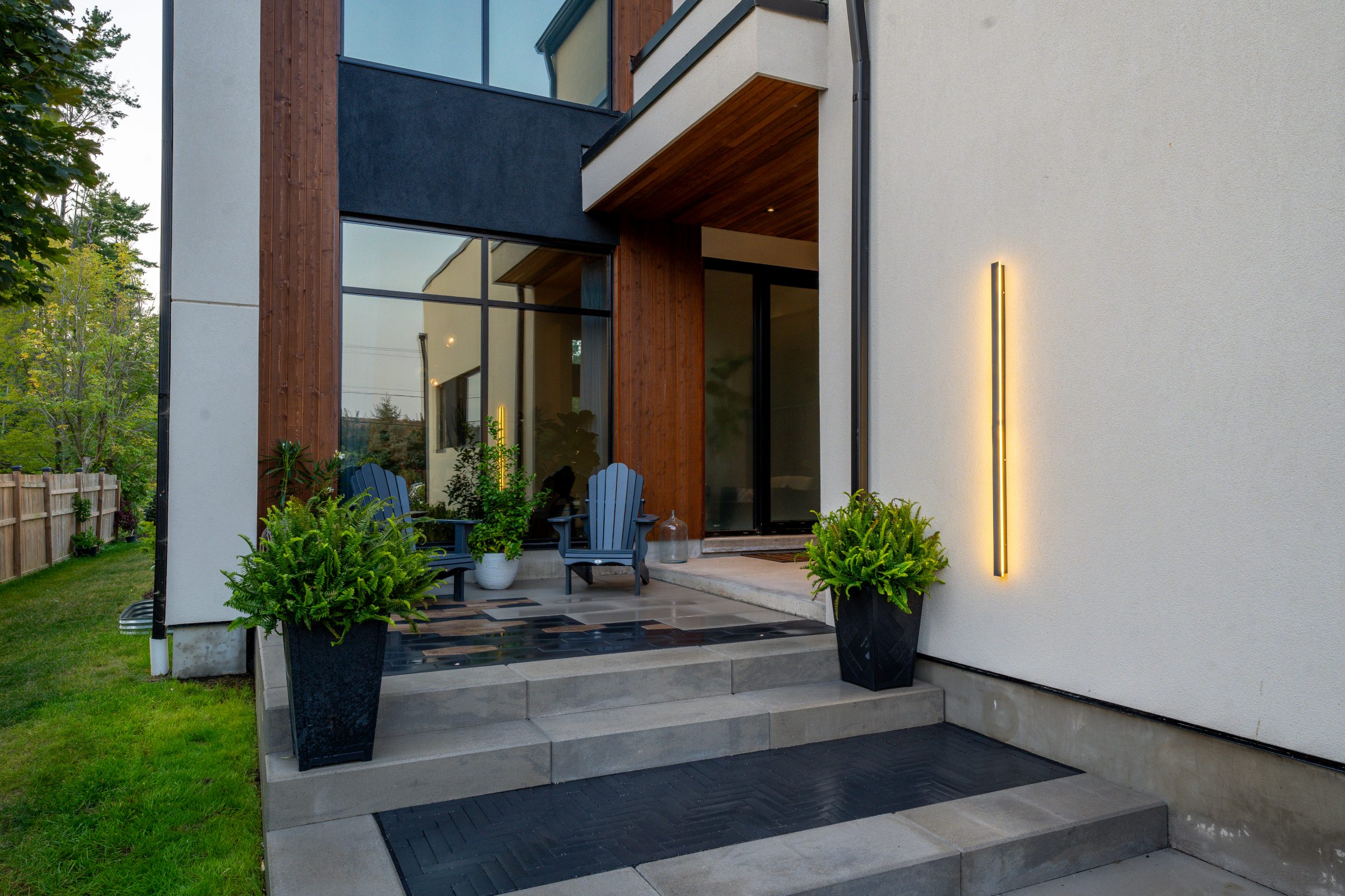 Modern house entrance with plants and chairs