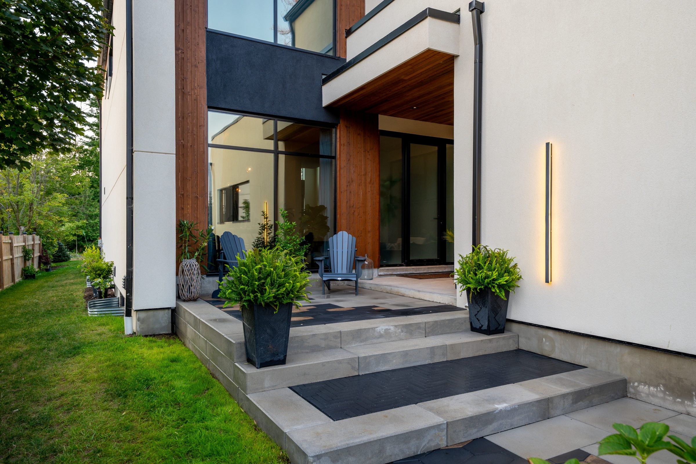 Modern house entrance with plants and chairs