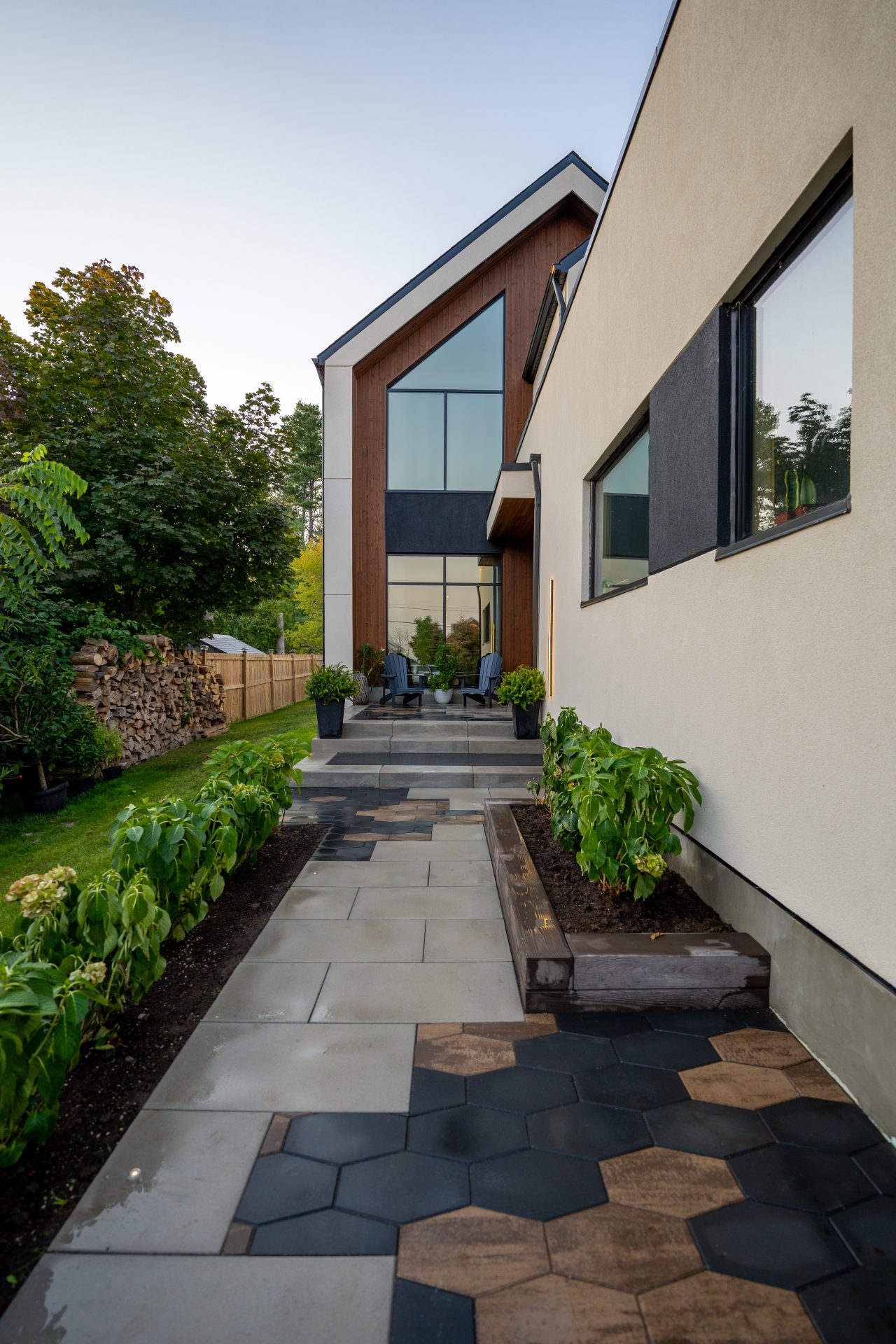 Modern house with landscaped pathway and plants.