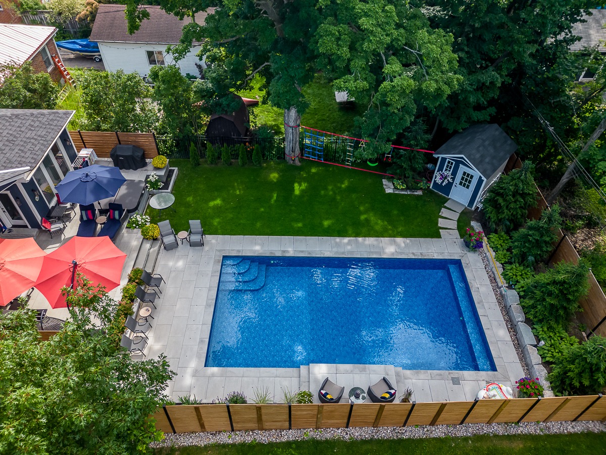 Backyard with pool, patio, and garden view.