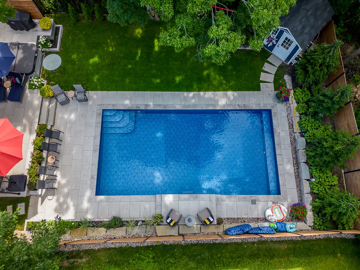 Aerial view of backyard pool and patio setup.