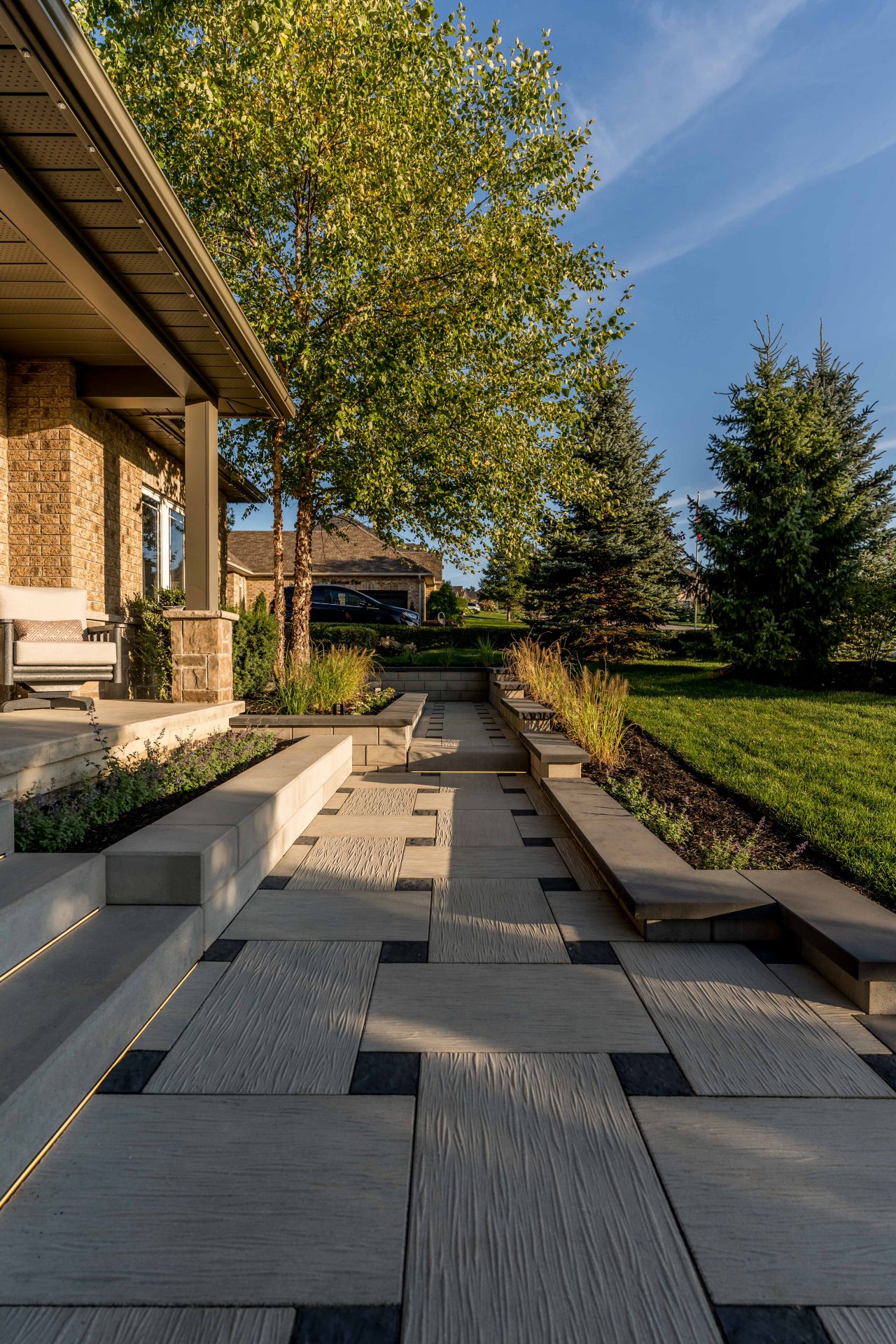 Modern patio with geometric stone path and greenery.