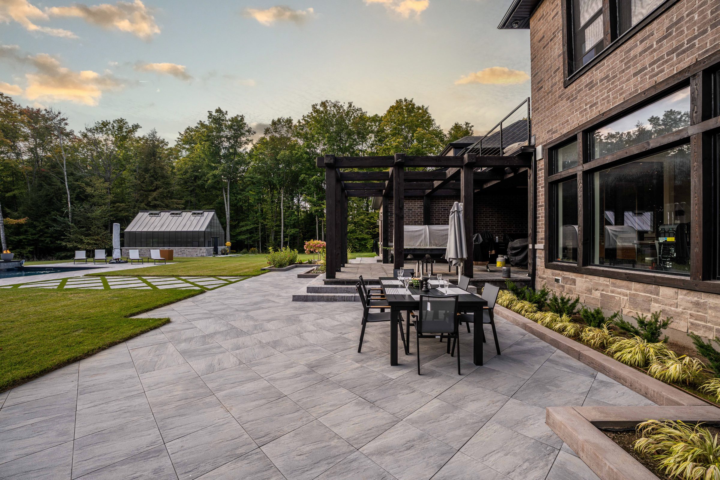 Modern patio with dining table and garden view