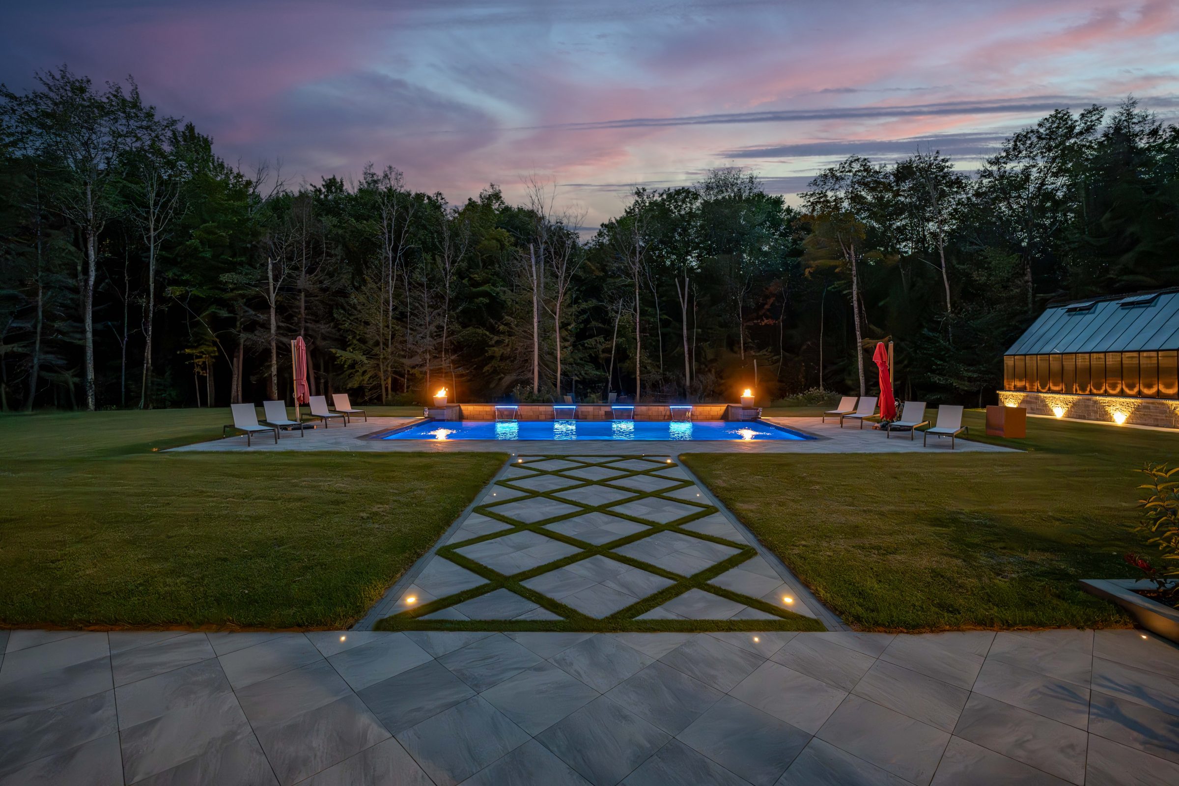 Luxury outdoor pool with evening lighting