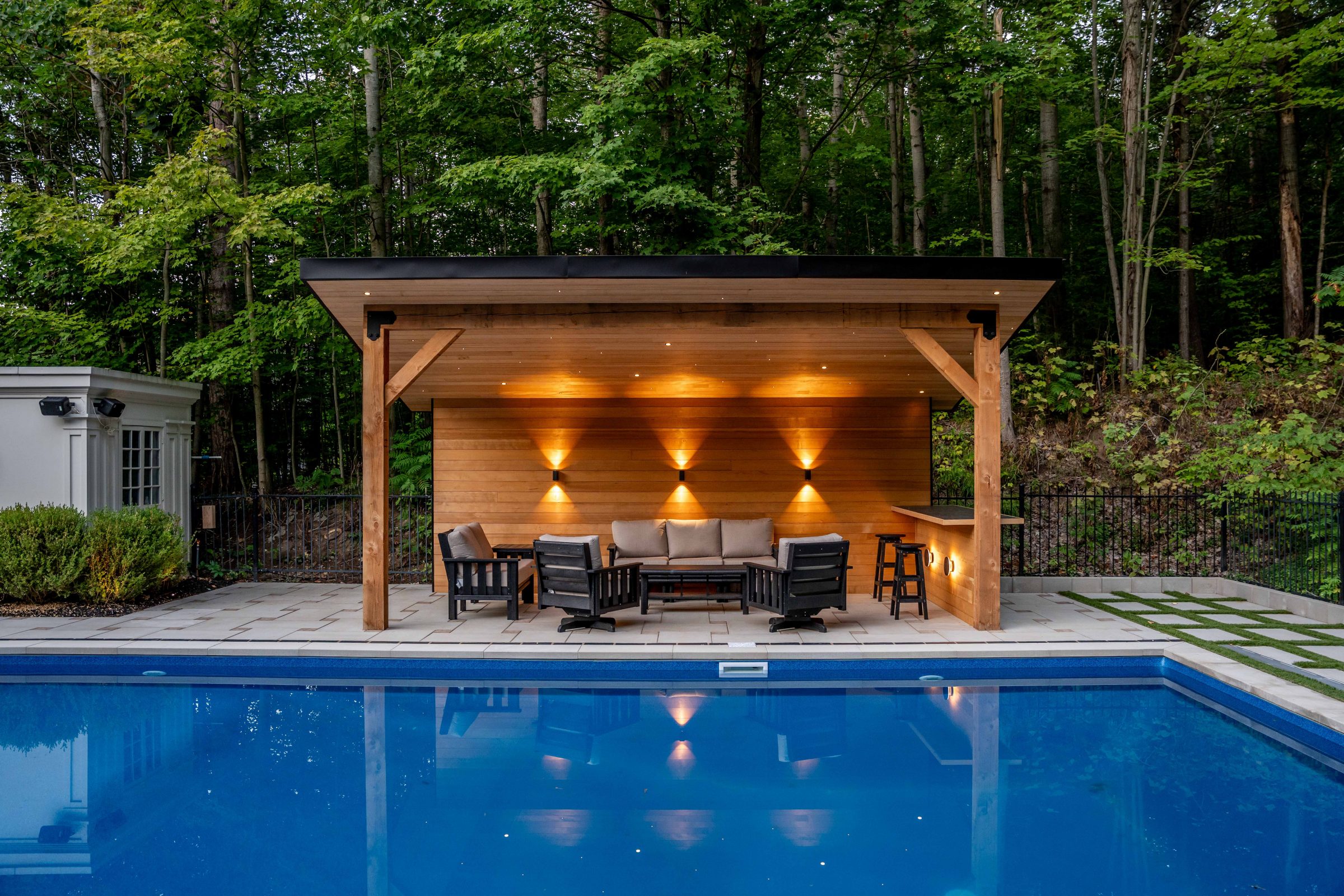 Cozy poolside patio with lights and seating