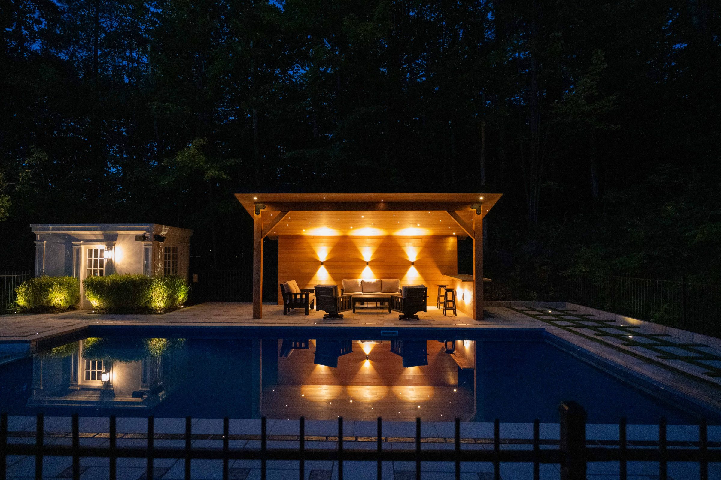 Illuminated poolside patio at night