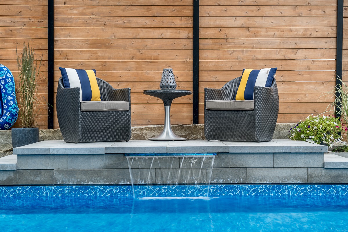 Outdoor patio with chairs and pool view