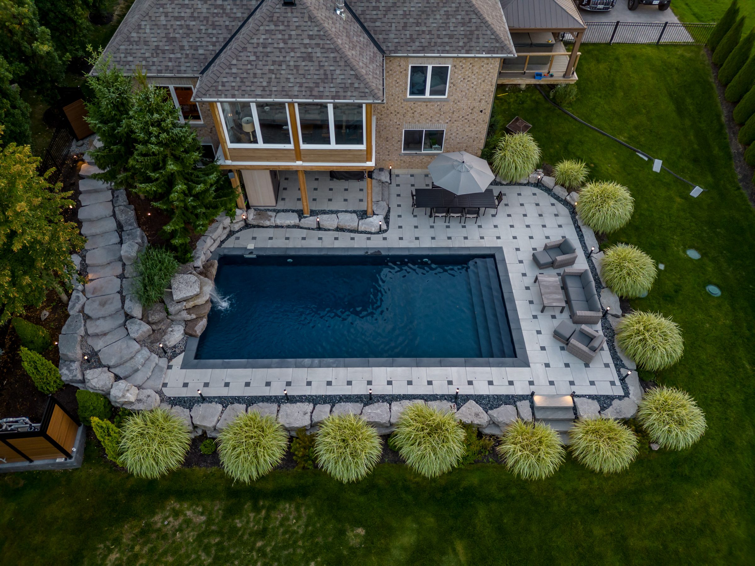 Aerial view of house with backyard pool.