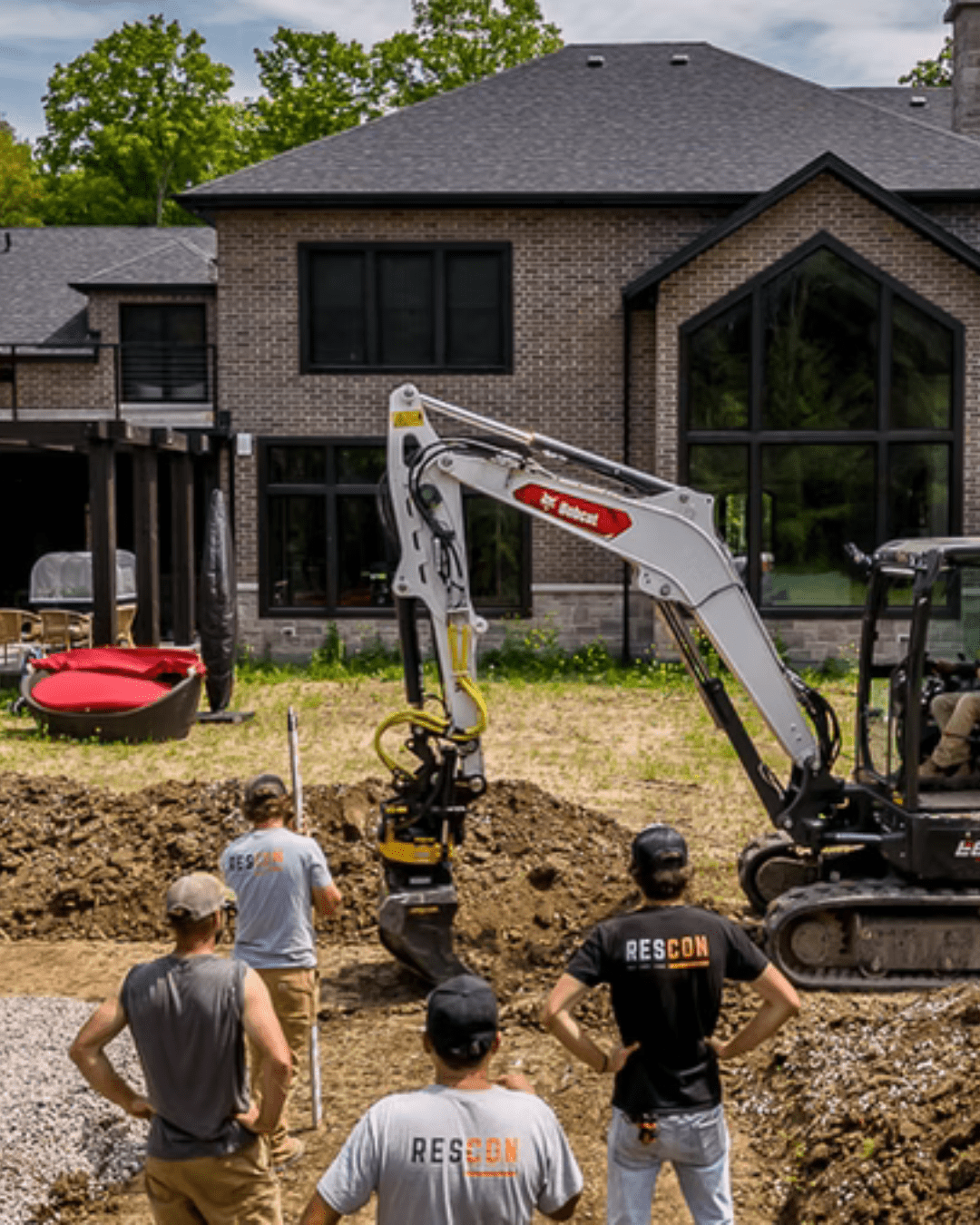 Construction team excavating backyard for home improvement.