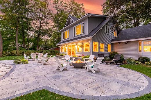 Cozy backyard with firepit at sunset.