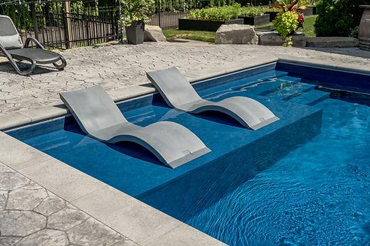 Modern pool with submerged lounge chairs