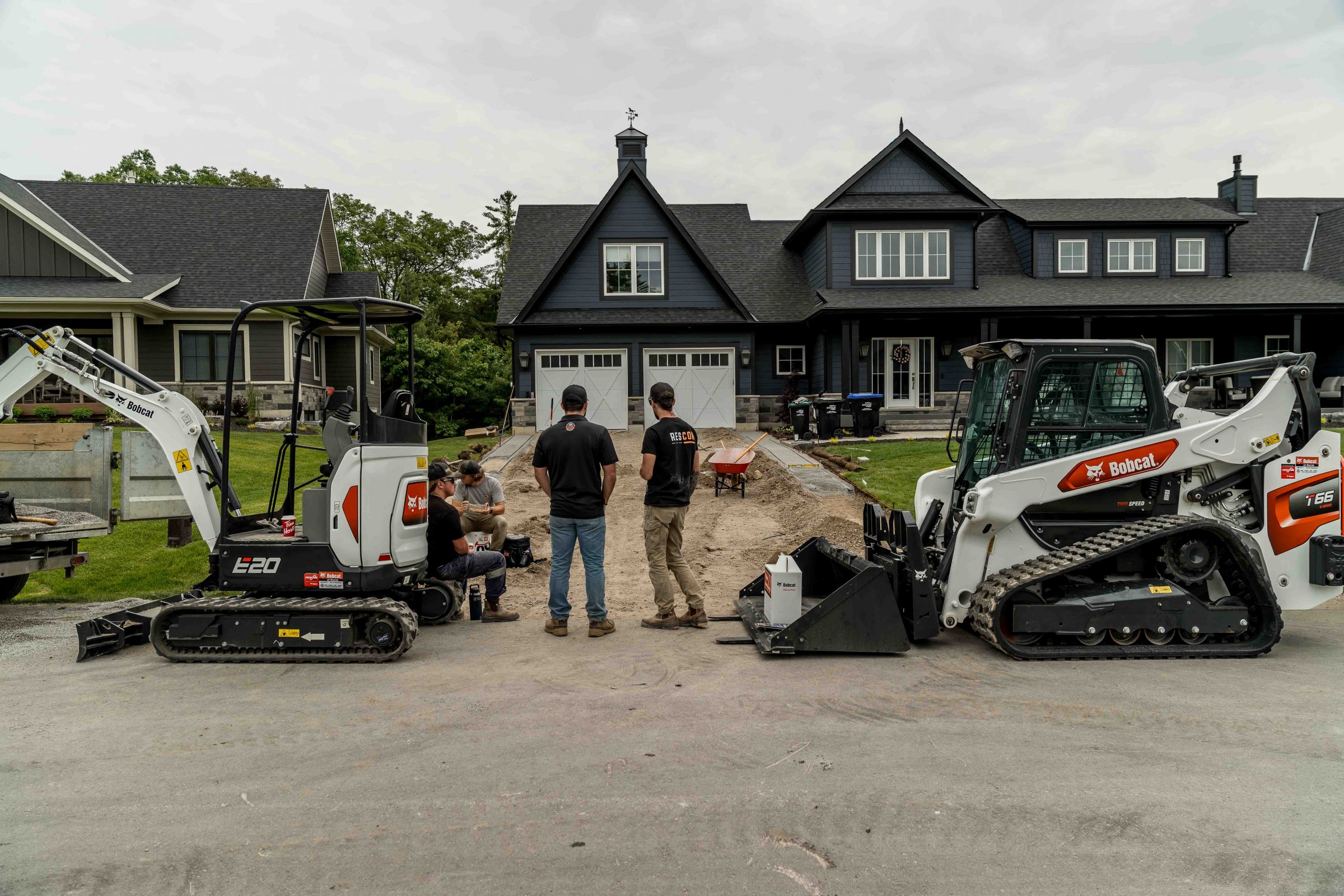 Construction crew working on residential driveway project.
